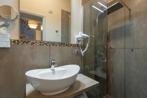 a bathroom with a white sink and a shower at Hotel Ristorante Ala d'Oro in Lugo
