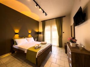 a bedroom with a bed with a teddy bear on it at Ten Number Suites in Limenas