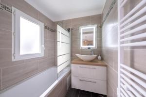 a bathroom with a sink and a mirror at D1 Maison de Charme proche Disney Val d'Europe in Dammartin-sur-Tigeaux