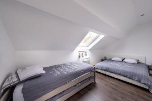 a bedroom with two beds and a window at D1 Maison de Charme proche Disney Val d'Europe in Dammartin-sur-Tigeaux