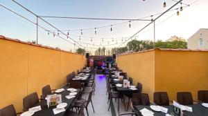 a row of tables and chairs on a patio at LA CASITA DE MANOLI in Chillarón de Cuenca