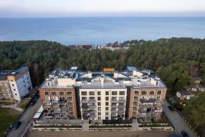 an overhead view of a building with the ocean in the background at Elegant Apartment Na Wydmach with Balcony and Parking by Renters in Międzywodzie