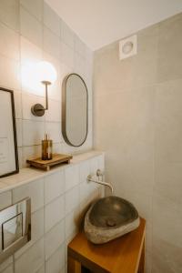 a bathroom with a sink and a mirror at Smaragda's Guest Rooms in Limassol +49 photos
