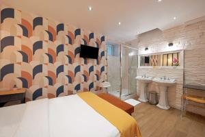 a bedroom with a bed and two sinks and a tv at Cosy and modern updated studio in Paris