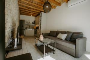 a living room with a couch and a table at Smaragda's Guest Rooms in Limassol