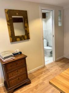 a bathroom with a dresser and a bathroom with a toilet at Centre Ahimsa in Verrières-le-Buisson