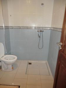 a bathroom with a shower with a toilet at B205 LOT AL WIFAQ Bensergao AGADIR in Agadir