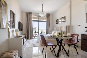 a bedroom with a bed and a table and chairs at Frank Porter - Jwelz By Danube in Dubai