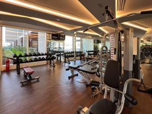 a gym with lots of treadmills and machines at Frank Porter - Jwelz By Danube in Dubai