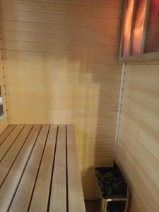 a sauna with a wooden bench in a room at Happy House Apartments in Špindlerův Mlýn