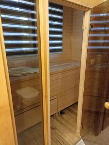 a sauna with a window and a wooden floor at Happy House Apartments in Špindlerův Mlýn