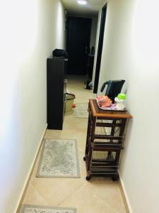 a room with a table and a black refrigerator at شاليه in El Alamein