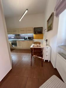 a living room with a table and a kitchen at Apartmány Zvonárska in Košice