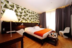 Cama ou camas em um quarto em Dal Moro Gallery Hotel