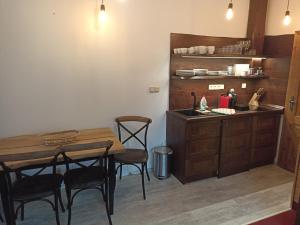 a kitchen with a table and chairs and a counter at Happy House Apartments in Špindlerův Mlýn