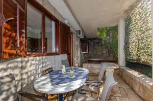 an outdoor table and chairs on a patio at Apartments Lorena in Stomorska