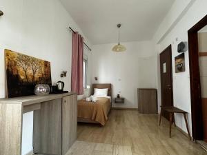 a bedroom with a bed and a table in a room at Skiathos Hills Studios in Skiathos +7 photos