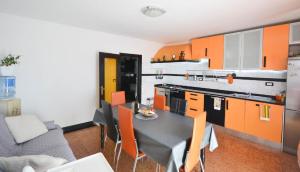 a kitchen with a table and some orange cabinets at Ferienwohnung für 6 Personen ca 90 m in Novigrad, Adriaküste Kroatien Westküste von Istrien in Karpinjan