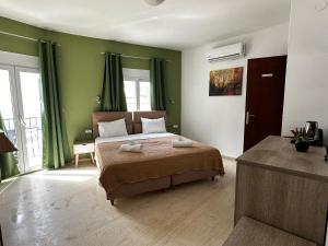 a bedroom with a bed with two towels on it at Skiathos Hills Studios in Skiathos