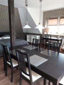a dining room with a black table and chairs at Apartment Sunline in Sulmin