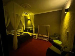 a bedroom with a mirror and a bed and a chair at ENJOY HOUSE BOUTİQE OTEL in Ankara