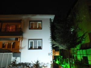 a white building with two windows at night at ENJOY HOUSE BOUTİQE OTEL in Ankara