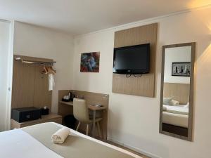 Cette chambre comprend un lit et une télévision murale. dans l'établissement Best Western Hotel & Spa Austria-La Terrasse, à Saint-Étienne