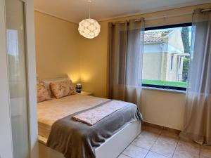 a bedroom with a bed and a large window at Simple Pleasure Verde Blu App in Barbati +13 photos
