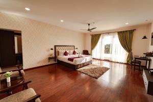 a bedroom with a bed and a living room at Windermere Hotel in Shillong