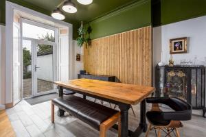 a dining room with a wooden table and two chairs at 58 Prestwick Road in Ayr