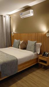 a bedroom with a bed with a air conditioner on the wall at Saphir Boutique Hotel in Kigali