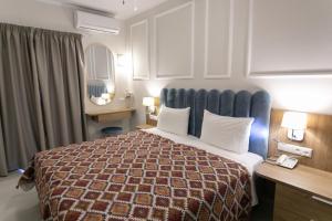 Posteľ alebo postele v izbe v ubytovaní Paradise Hotel