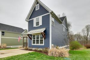 a blue house with a flag in the yard at Beautiful cottage next to Tims Ford Lake in Tullahoma