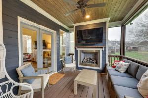 a screened in porch with a fireplace and a tv at Beautiful cottage next to Tims Ford Lake in Tullahoma
