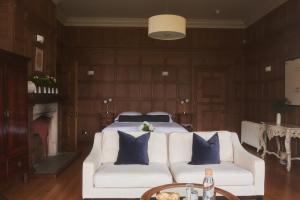 a living room with a white couch and a bed at River Arts Club in Maidenhead