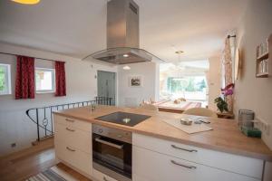 a kitchen with a sink and a stove top oven at Ferienhaus in Seefeld In Tirol mit Großer Terrasse in Seefeld in Tirol