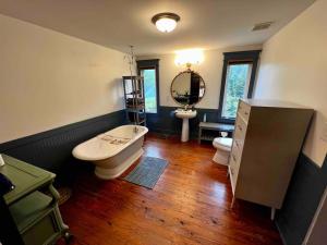 a bathroom with a tub and a sink and a toilet at Nashville Fatherland Cottage in Nashville +43 photos