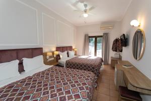 Posteľ alebo postele v izbe v ubytovaní Paradise Hotel