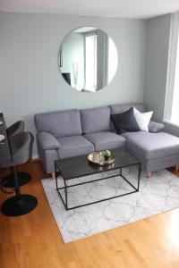 a living room with a couch and a mirror at Ferienwohnung für 2 Personen ca 30 qm in Haugesund, Südnorwegen in Haugesund