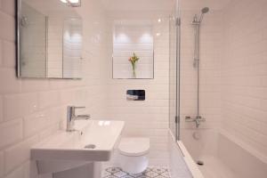 a bathroom with a sink and a toilet and a shower at Chy An Gweal Farm Cottage in Carbis Bay +25 photos