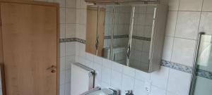 a bathroom with a mirror and a sink at Waldblick Nordhorn in Nordhorn