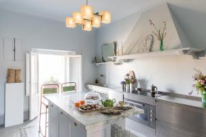 a kitchen with a counter and a sink and a stove at Casa Iris in Orbetello +18 photos