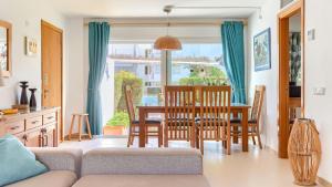 a kitchen and dining room with a table and chairs at Bellresguard Garden Flat C in Port de Pollensa