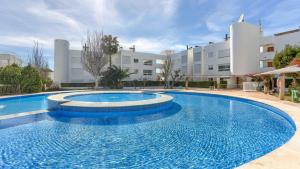 a large swimming pool in front of a building at Bellresguard Garden Flat C in Port de Pollensa
