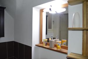 a bathroom with a sink and a mirror at Maison au Loup - Superbe ancien hotel particulier du XVIe siècle au cœur de la vieille ville du Puy in Le Puy-en-Velay