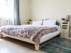 a bedroom with a bed with a leopard blanket at 3BR Serene Bungalow in Lower Kabete in Nairobi