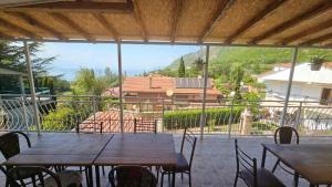 a patio with tables and chairs and a view of a house at Villa Karolina in Ohrid