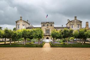 a large building with a fountain in front of it at The Courtyard at Manor Estate near Stonehenge in Salisbury