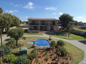 une grande maison avec une piscine dans la cour dans l'établissement La Maison on Vaal Bed and Breakfast, à Denysville