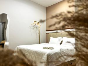 a bedroom with a bed with two wedding rings on it at Mana Mana Hotel • Melaka • in Melaka